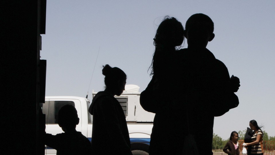 A silhouette of an immigrant family