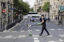 A police officer removes an electric scooter from the area around Notre-Dame cathedral in Paris.