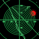 A green-and-black radar screen with a red dot