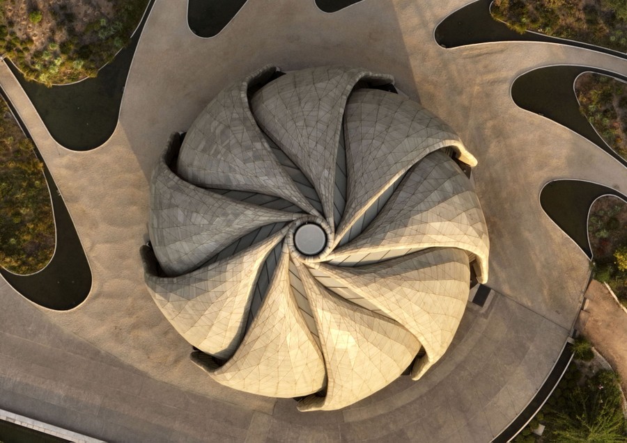 An aerial view of a spiral-shaped domed temple