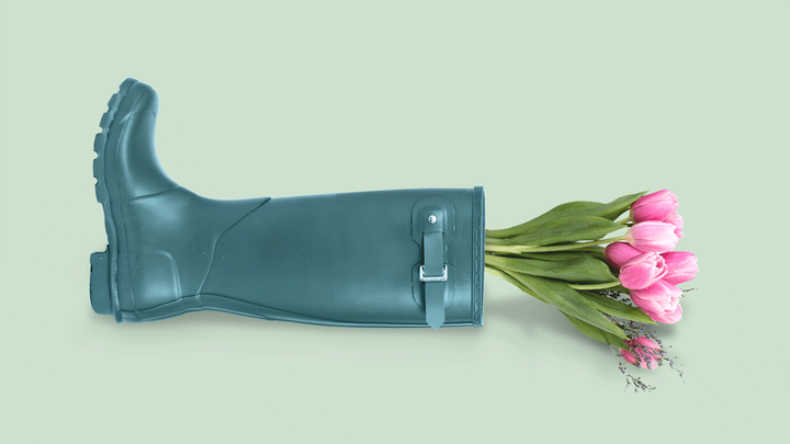 rain boot containing a bouquet of tulips