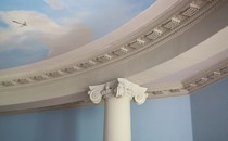 Close-up of a column holding up a ceiling painted to look like the sky