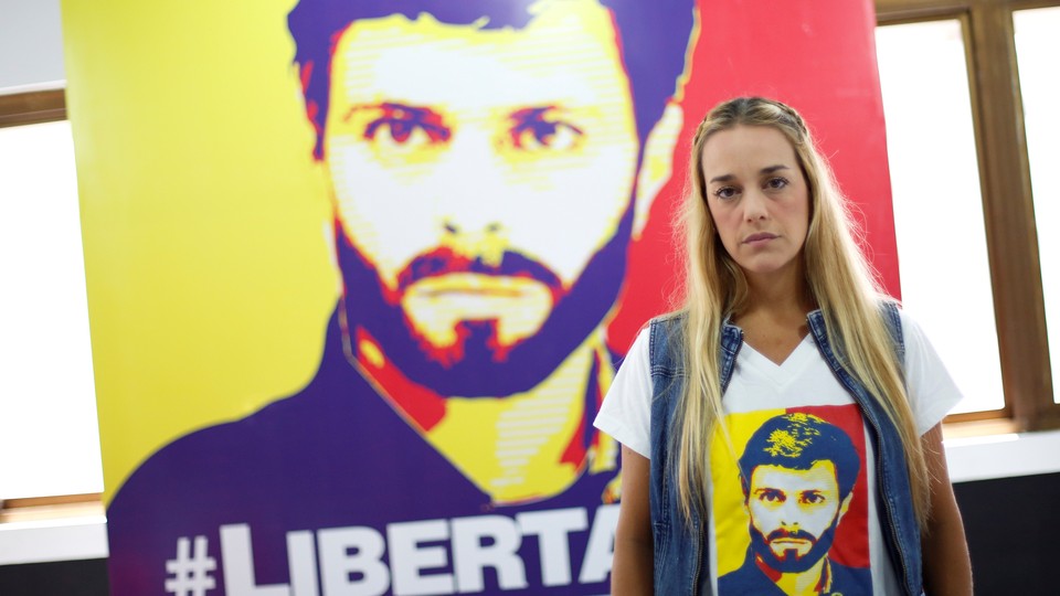 Lilian Tintori, wife of jailed Venezuelan opposition leader Leopoldo Lopez, poses for a picture in front of a poster depicting her husband.