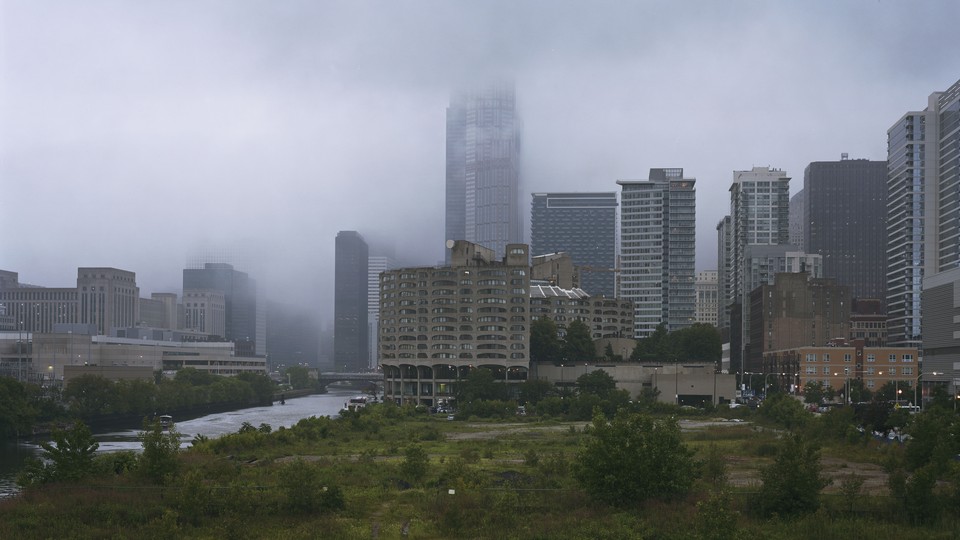 Clouds obscure the upper floors of a skyscraper in Chicago.