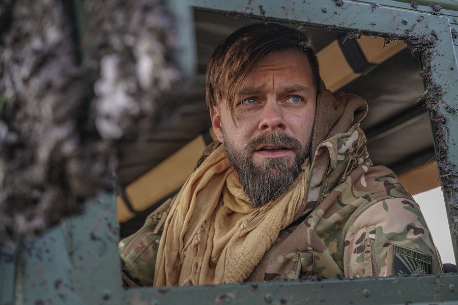 A soldier seated inside a military vehicle