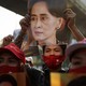 Protesters hold up an image of Aung San Suu Kyi out the Myanmar embassy in Bangkok.