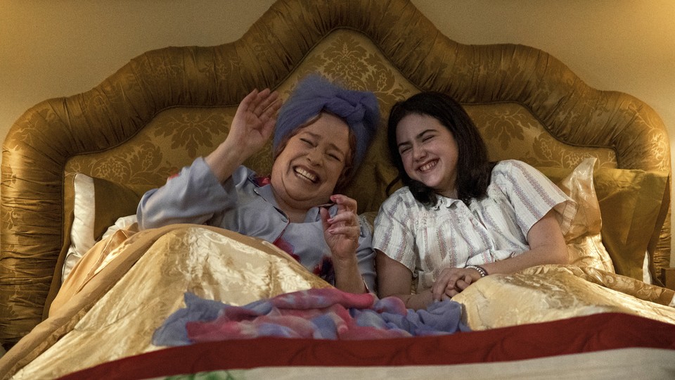 Kathy Bates and Abby Ryder Fortson laughing in a bed