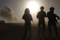 Silhouettes of armed soldiers in contralux