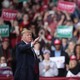 Donald Trump at a rally in Michigan. He is standing in front of a crowd.