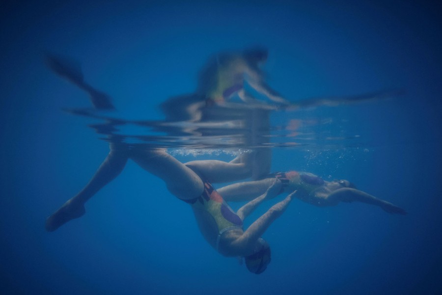 Two swimmers underwater in a pool