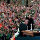 Former President Bill Clinton waves to a large crowd waving Irish and American flags in Dublin.