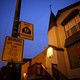 Taken at night, the photo shows a yellow safe-passage sign reading "Warning Safe School Zone" 