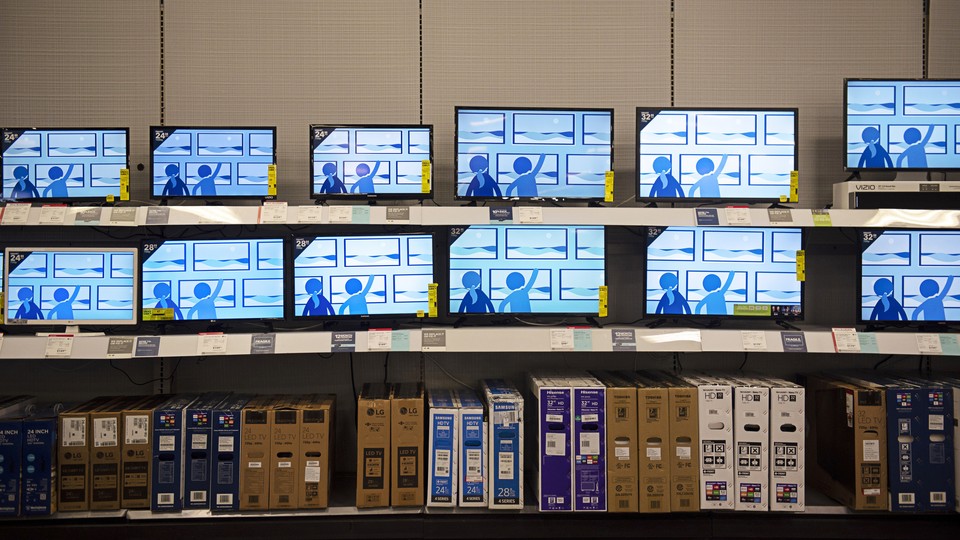 A photograph of rows of televisions in a Best Buy
