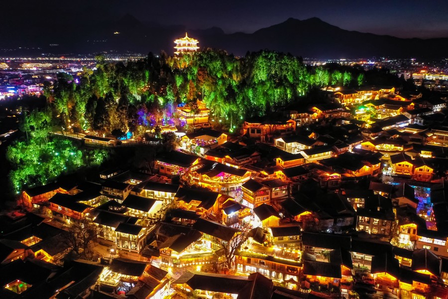 An aerial view of an old town in China, illuminated at night