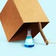 An illustration of a chemical beaker under a box trap