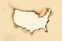 Burning piece of paper in the shape of America