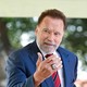A photo of Arnold Schwarzenegger speaking at the annual naturalization ceremony at Mount Vernon.