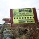 A truck crosses from the Republic of Ireland into Northern Ireland, past a sign that reads, "Border communities against Brexit."