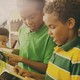 Young children perusing books at a Scholastic book fair