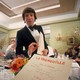 A diner's-eye view of a menu and waiter