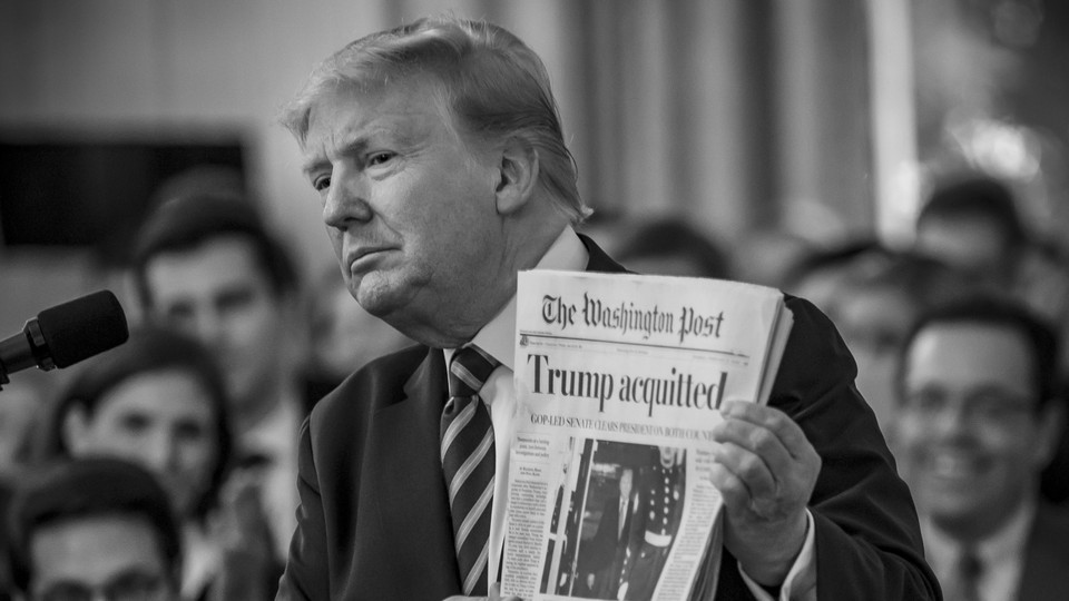 Donald Trump holding up a copy of the Washington Post.