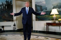 President Trump stands in the White House with arms spread