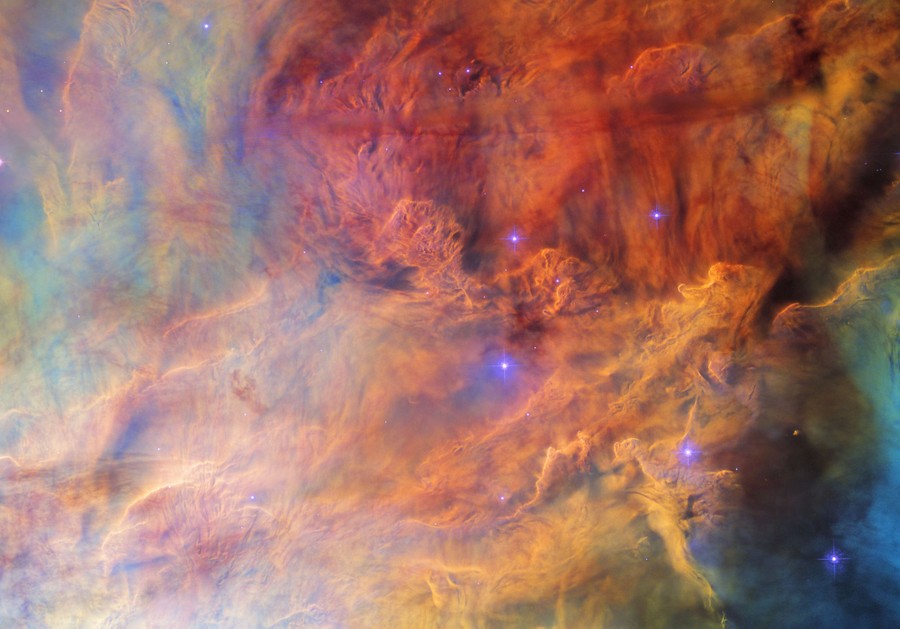 An image filled with multicolored roiling clouds, and a handful of blue stars.