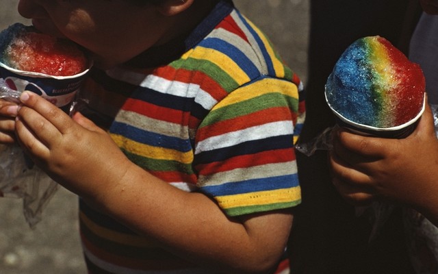 Two children eating snowcones.