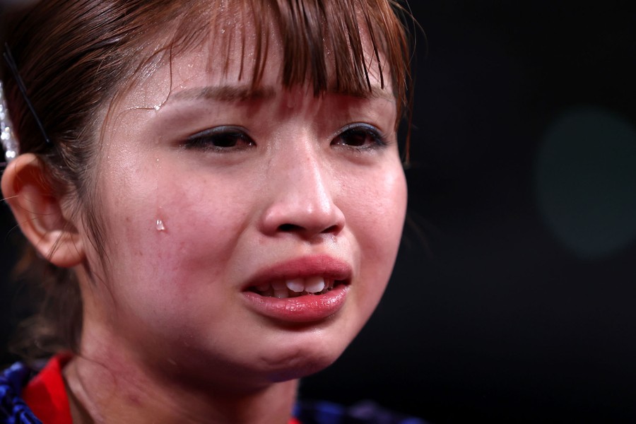 A table-tennis player displays emotion on her face after winning a match.