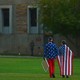 Two boys' backs face the camera. They are wearing American-flag apparel.