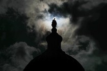 Dark clouds move over the Statue of Freedom on top of the U.S. Capitol Dome