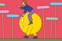 A person rides an ambulatory smiley face in the opposite direction of pointing signs.