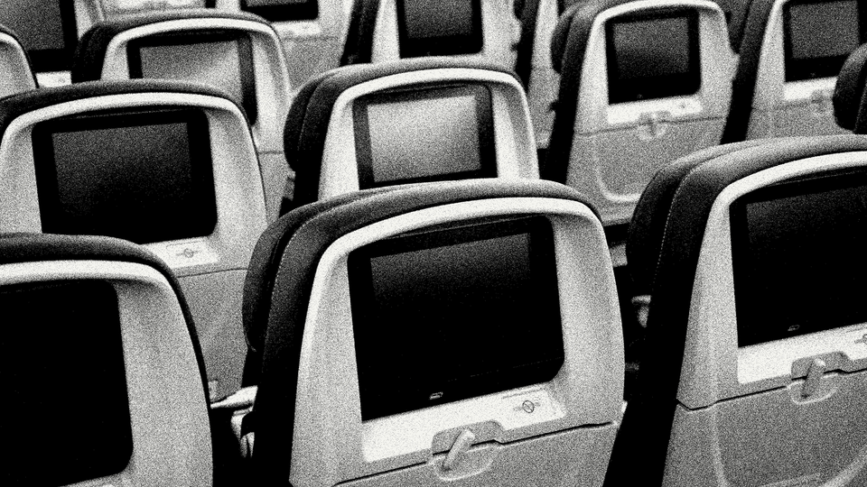 A black-and-white photo of a row of airplane seats
