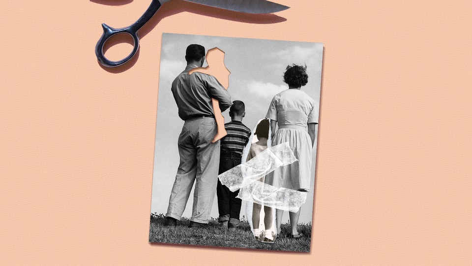 A black and white photo of a family facing away from the camera, with a cut-out where a child should be in its fathers arms