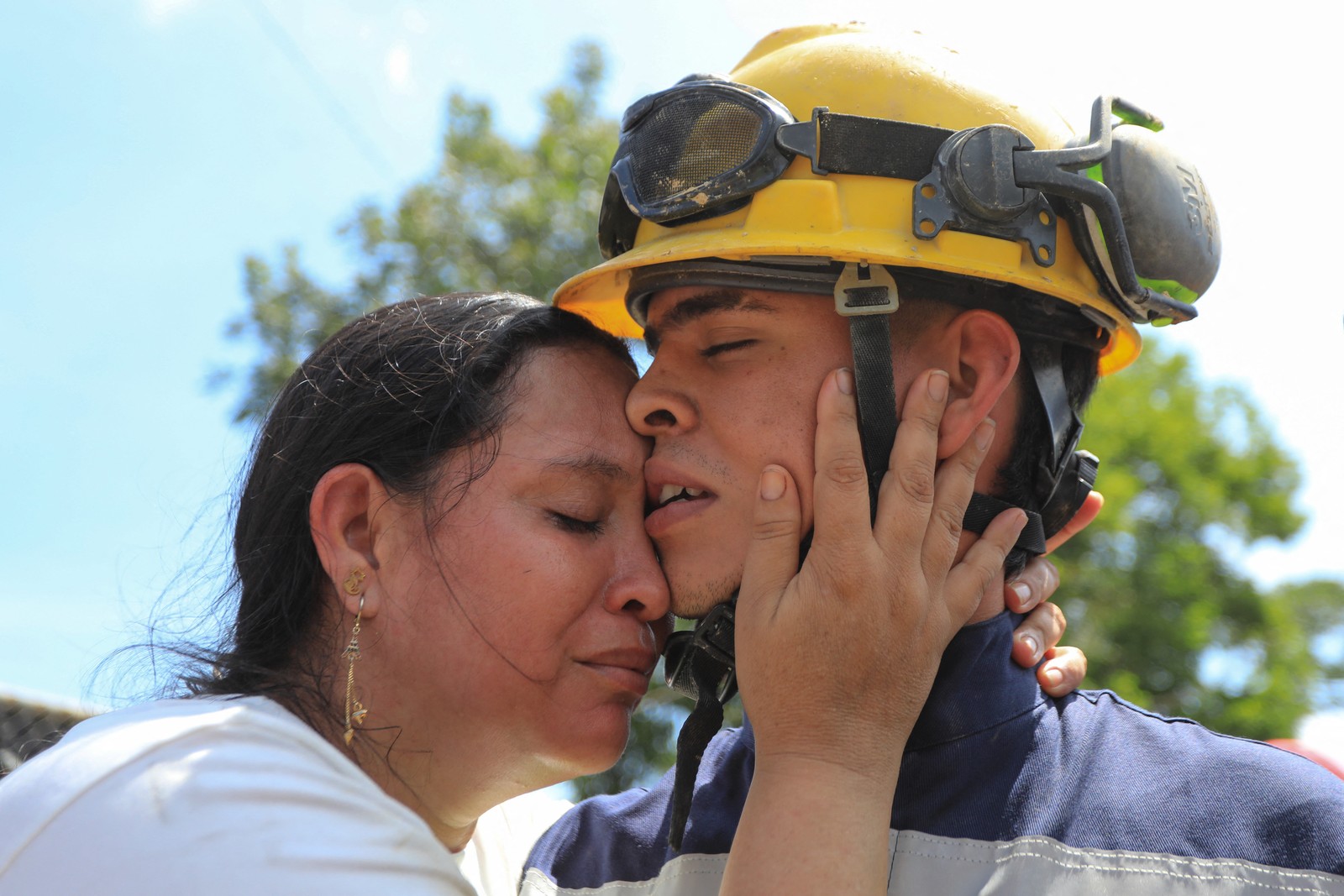 Two people embrace after trapped miners were rescued.