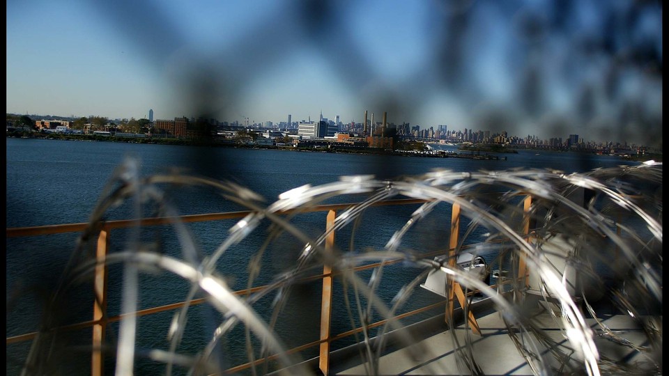 A view of Manhattan through barbed wire at a Rikers Island facility