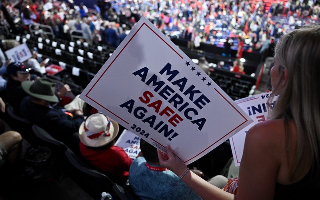 An attendee holds a "Make America Safe Again" sign during the second day of the 2024 Republican National Convention