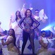 Maya Rudolph in a glittering bodysuit flanked by dancers