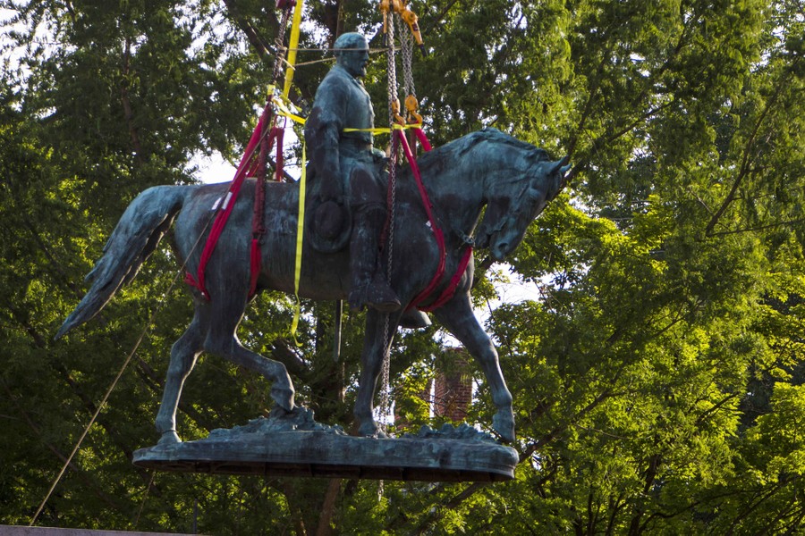 Workers remove the monument of Confederate General Robert E. Lee in Charlottesville, Virginia.