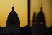 An photograph of the U.S. Capitol against a yellow sky