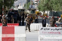 Afghan security next to road barriers