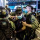 A riot police officer detains a man during a protest outside a Hong Kong shopping mall.