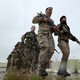 Christians volunteers, who have joined the Kurdish Peshmerga fighters, take part in a training session by coalition forces in a training camp.