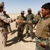 A U.S. Marine shakes hand with Afghan National Army soldiers.