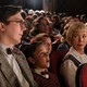 Paul Dano, Mateo Zoryon Francis-DeFord, and Michelle Williams sit in a movie theater in "The Fabelmans"