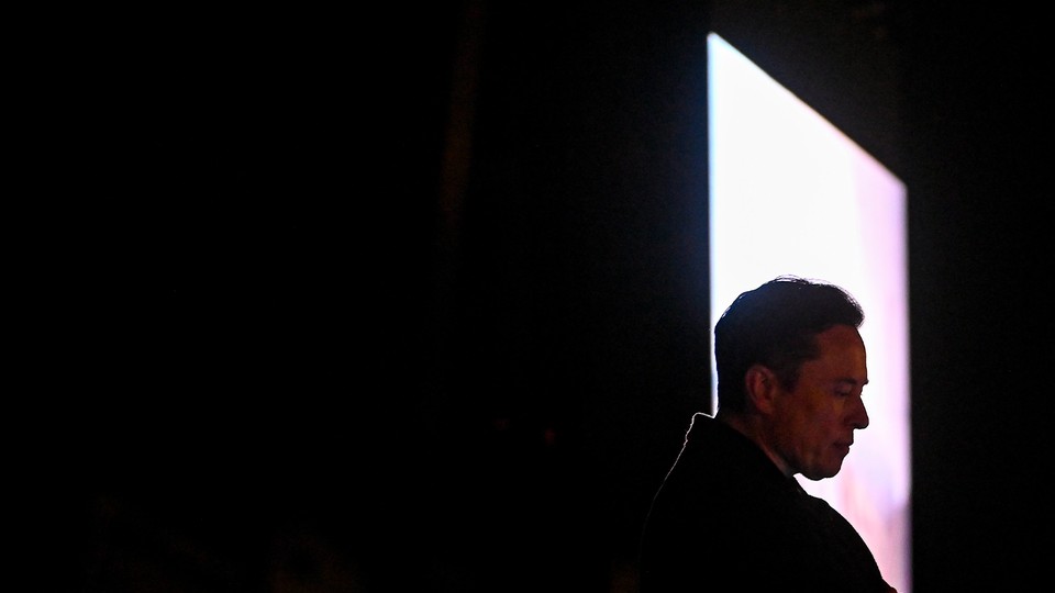 Elon Musk's head is framed in a bright quadrilateral figure cut into a dark background.