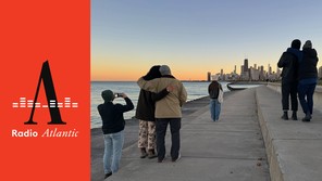 People look at the Chicago skyline at dusk.