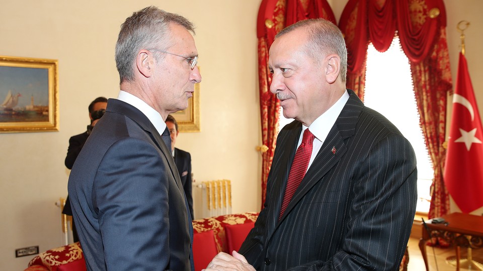 Recep Tayyip Erdoğan shakes hands with Jens Stoltenberg.
