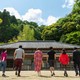 Eight adults walking toward a house in Japan