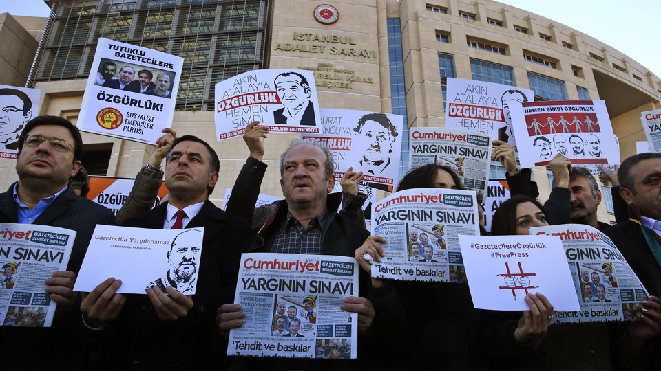 Demonstrators hold copies of Cumhuriyet outside the court where several of the newspaper's employees were on trial in 2017.